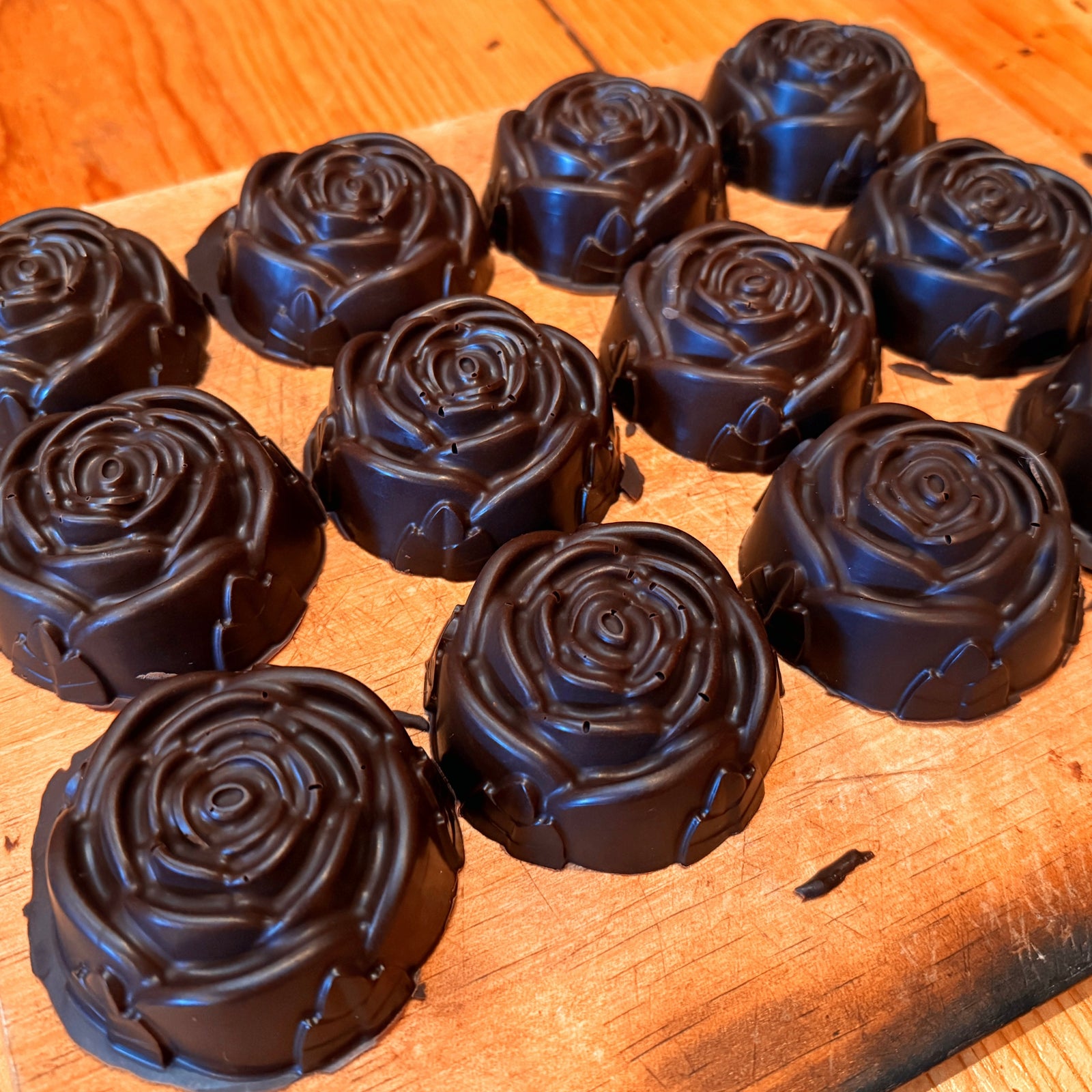 Dark chocolate roses on a wooden surface